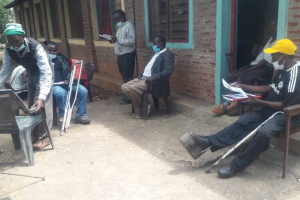 People with disabilities sitting in front of a house in Embu county