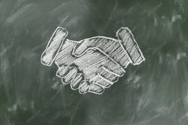 Picture of a Chalkboard with a chalk drawing of a handshake